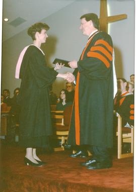 James Pankratz giving Nicole Ens her diploma