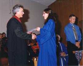John H. Unger giving Anna Klassen her certificate