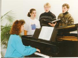 Students singing / playing piano