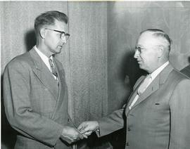 Willie G. Baerg and F.H. Friesen shaking hands