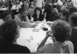 Delegates discuss around tables