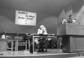 John E. Toews at the pulpit