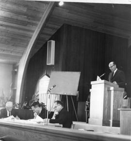 H.H. Voth behind the pulpit
