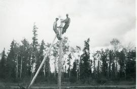 Two men on a pole