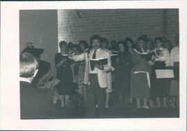 Congregational singing, conducted by Ray Plett - 2 photos
