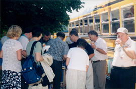 getting on bus for return flights to Manitoba