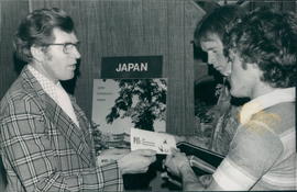 Dan Koop, Re. for Japan Ev.Mission talking to two SBI students