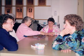 Women enjoying games and visiting - two pictures