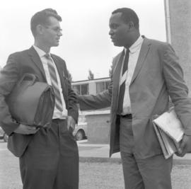 Ed Riddick at right in conversation with a young man