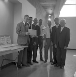 Board members of Mennonite Historical Society of Manitoba examine certificate