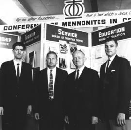 Henry P. Epp, CMC moderator poses with three men
