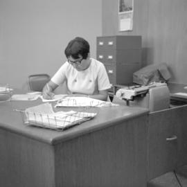 Irene Heinrichs, secretary for Mennonite Radio Mission, works at her desk