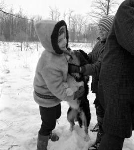 Children playing with a dog while the adults created beams for the restoration of the Brubacher H...