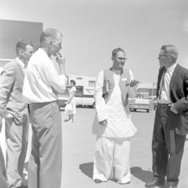 Missionary Kenneth Bauman of India talks with others