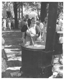 Mrs. Serenus Schwartzentruber stirring soap in a kettle