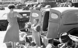 An old order Mennonite woman selling produce from the back of her vehicle at the old Kitchener Fa...