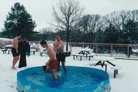 Students in a wading pool on the patio of Conrad Grebel