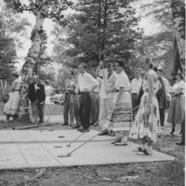 Young people playing shuffle board at Chesley Lake Camp