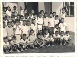 Children in front of the Pati Javanese Mennonite Church wearing clothes from their Christmas bundles