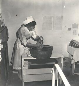 Margaret Wiens washing a child at Pusan Children's Hospital