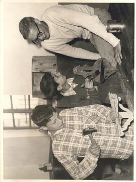 Pax worker Joe Haines supervises boys doing a woodworking project at an MCC orphanage