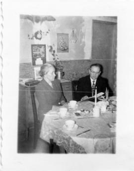 Mary & Peter Koop looking at a book in B.C 1957