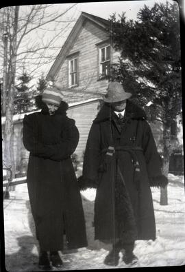 Two people bundled up in long coats
