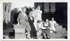 Group of seven Maedchenheim ladies on the steps of a school.