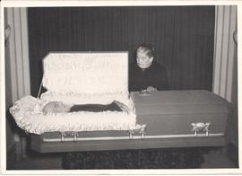 Agatha Friesen (Rogalsky) beside casket with Peter Isaak Friesen