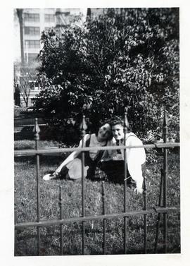 Two unidentified ladies from Ebenezer Maedchenheim behind fence