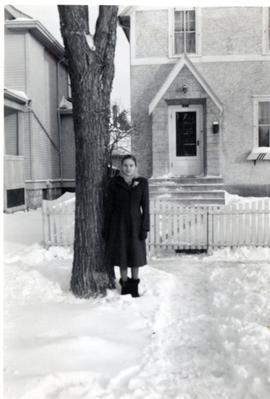 Edith outside of 46 Cobourg Ave in winter