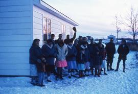 Indigenous group next to building, winter