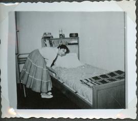 Female Student Making Dorm Bed
