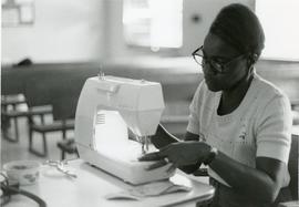 Beryl Demetrius (Jamaica) at a sewing machine