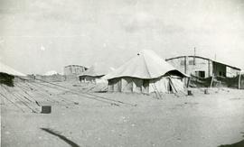 Tent and surrounding building in refugee camp, Egypt
