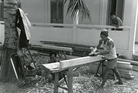 Carpenter planing a piece of wood in Kampuchea