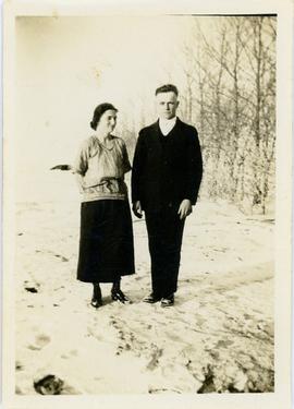 Unidientified man and woman standing in a snowy field