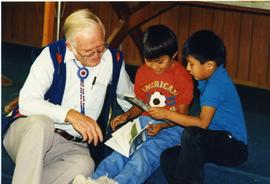 Malcolm Wenger reading with two boys
