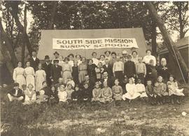 Children and adults from the South Side Mennonite Brethren Mission in front of tent