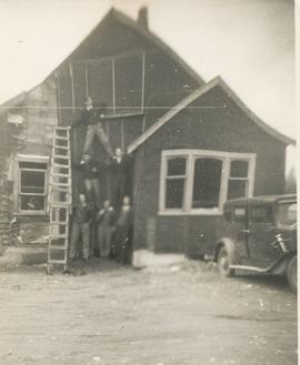 Six young men in front of a building