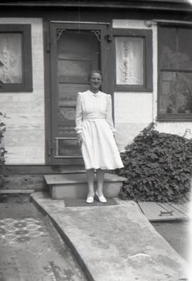 Woman at Door of House